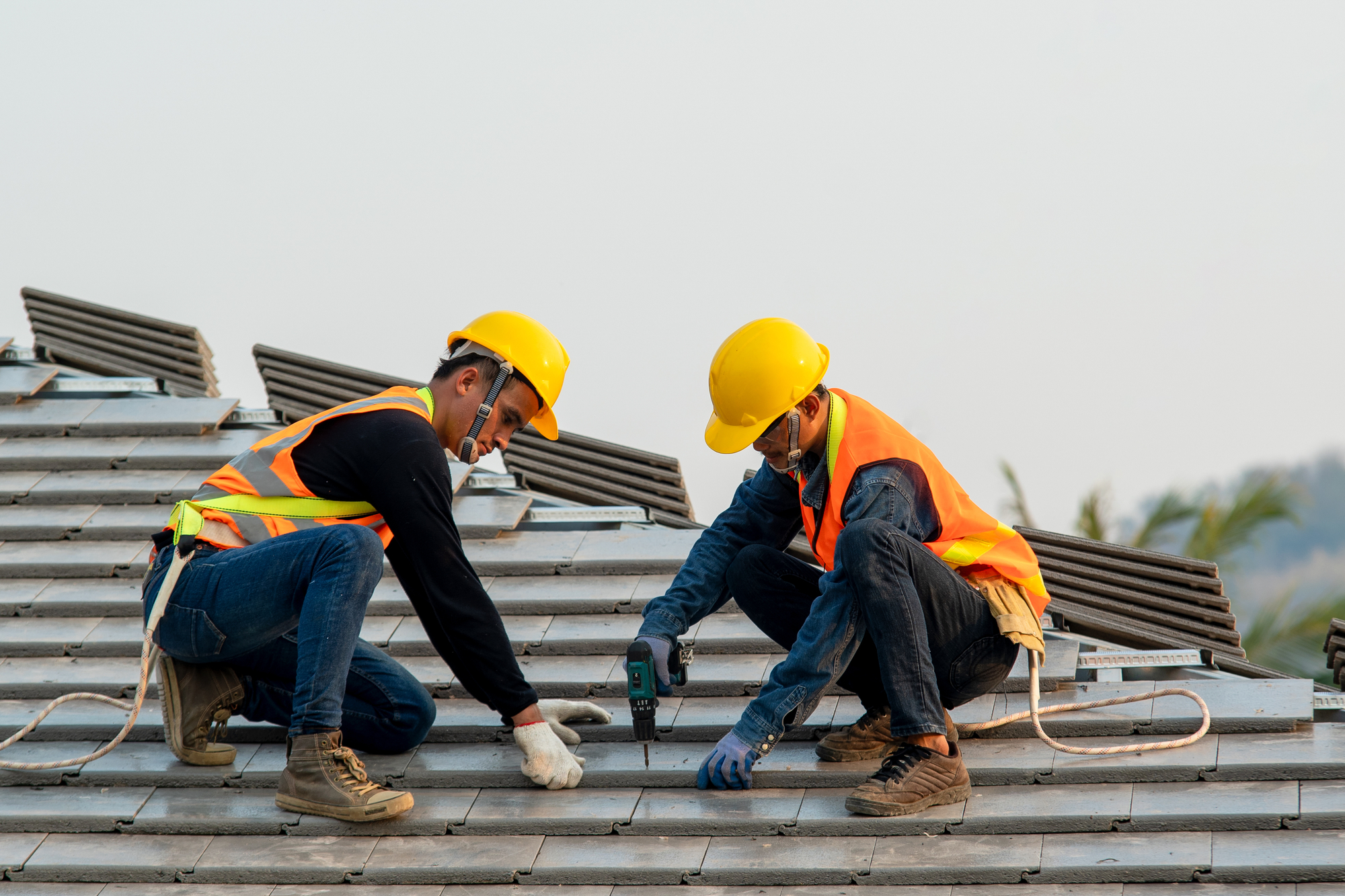 Roofer Workers Installing Concrete Roof Tile On Top Roof