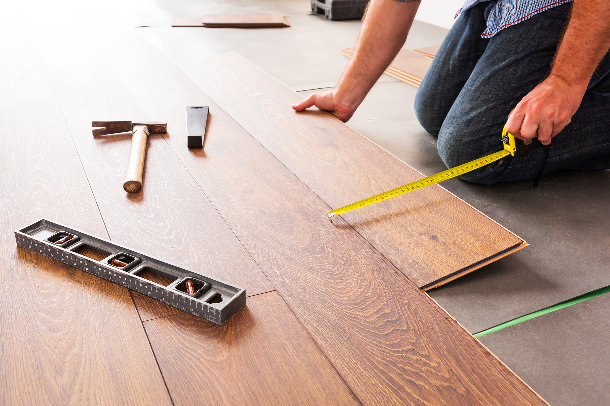 Man Installing New Laminated Wooden Floor